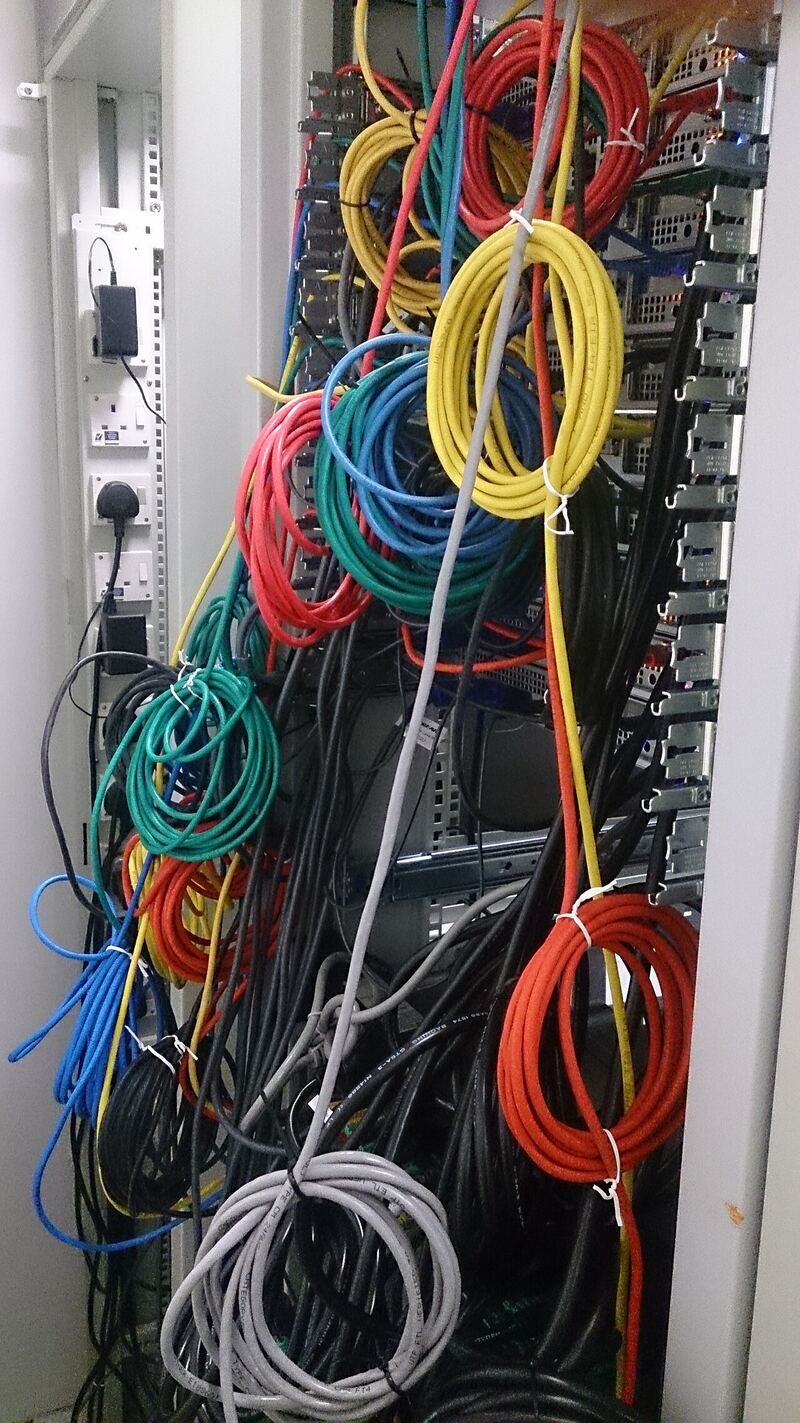 Organized network cabling in a server room, representing connected application infrastructure