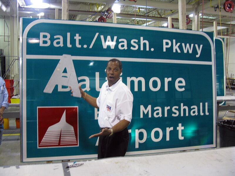 Inside a sign fabrication shop where signage is produced from cut-ready files